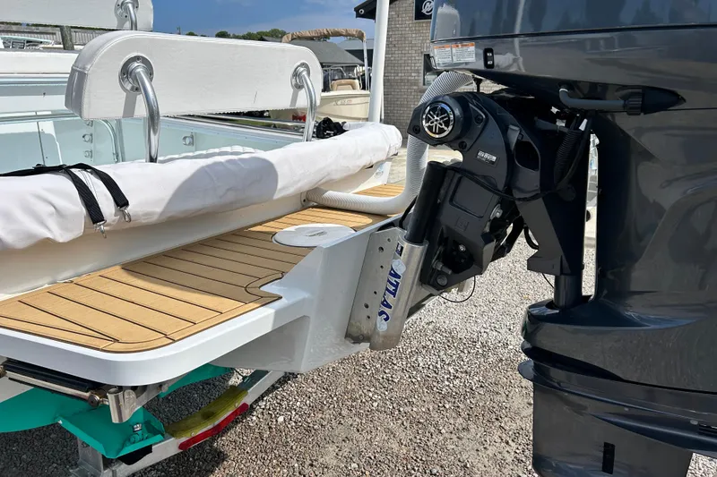 Slide: The Image of 2025 Dragonfly Boatworks Spanish Wells 21 with outboard motor and teak deck detail. - 8