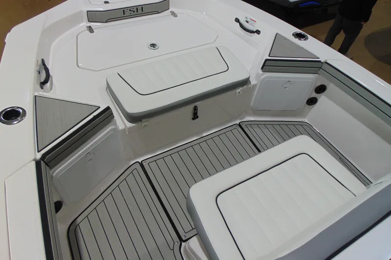 Slide: The Image of 2026 Yamaha Boats 195 FSH Sport interior with cushioned seating and storage compartments. - 10