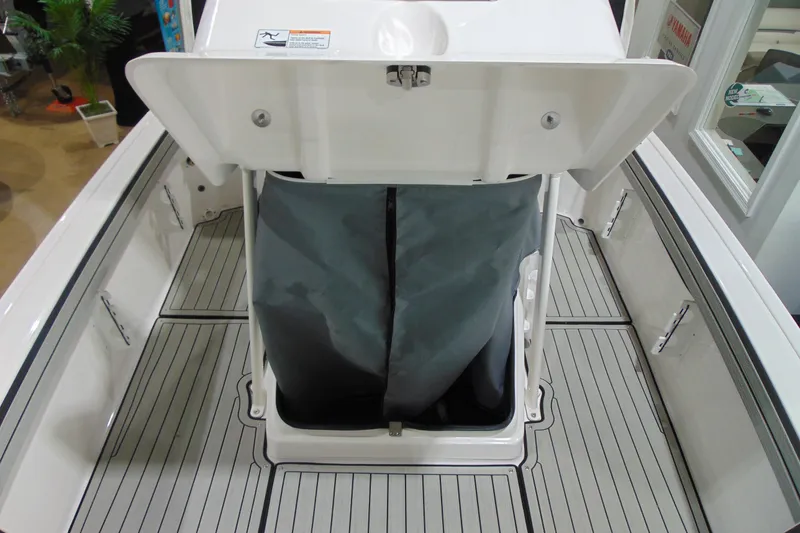 Slide: The Image of 2026 Yamaha Boats 195 FSH Sport interior storage compartment with open hatch. - 13