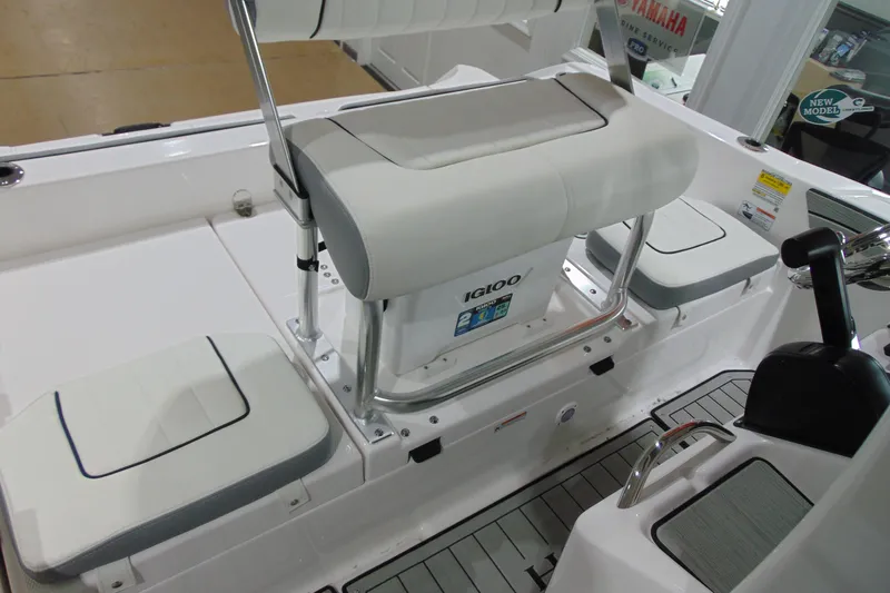 Slide: The Image of 2026 Yamaha Boats 195 FSH Sport interior with seating and Igloo cooler. - 14
