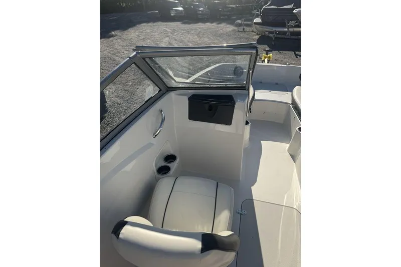 Slide: The Image of 2016 Stingray 191DC (OB) boat interior with seating and windshield. - 12