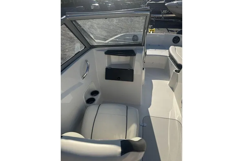 Slide: The Image of 2016 Stingray 191DC (OB) boat interior with seating and cup holders. - 13
