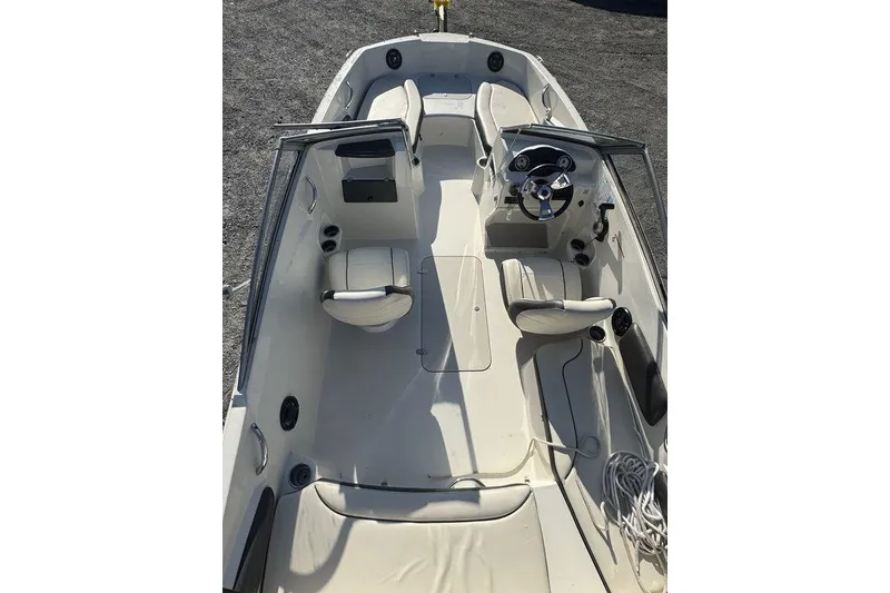 Slide: The Image of 2016 Stingray 191DC (OB) boat interior with seating and steering wheel. - 18