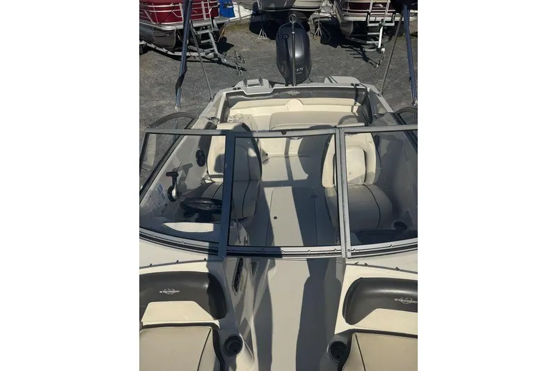 Slide: The Image of 2016 Stingray 191DC (OB) boat interior with seating and steering wheel. - 19