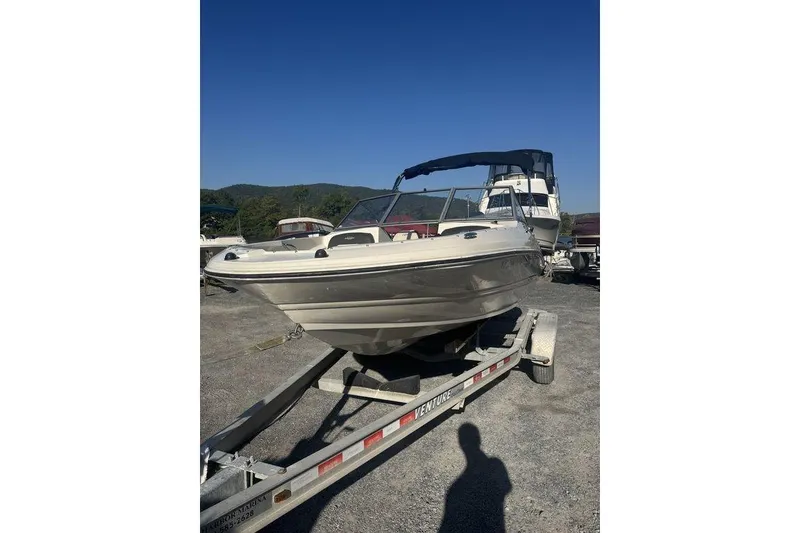 Slide: The Image of 2016 Stingray 191DC (OB) boat on trailer under clear blue sky. - 21