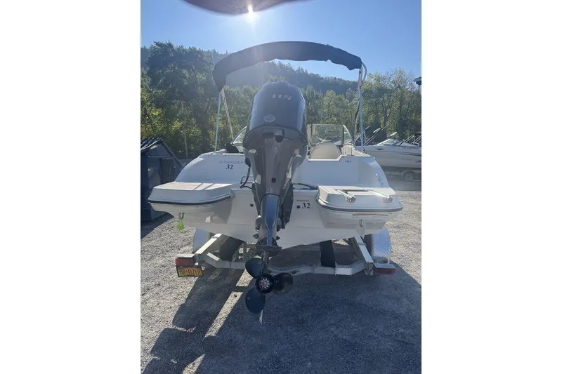 Slide: The Image of 2016 Stingray 191DC (OB) boat with outboard motor, parked on a trailer. - 23