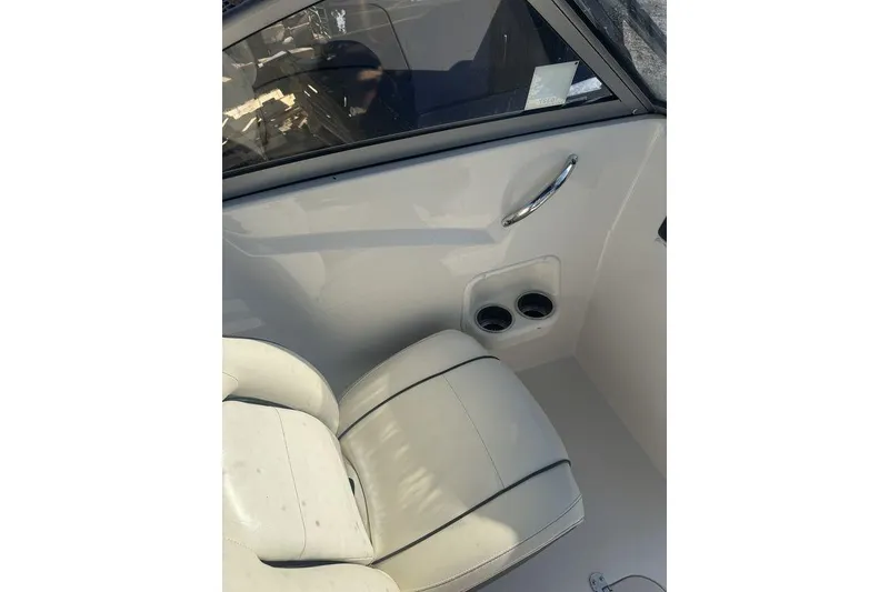 Slide: The Image of 2016 Stingray 191DC (OB) boat interior with white seating and cup holders. - 5