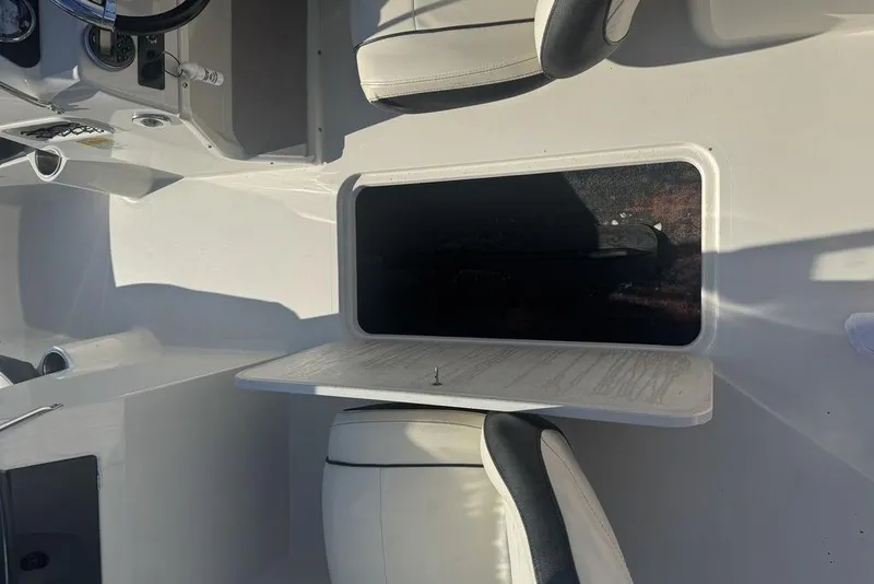 Slide: The Image of 2016 Stingray 191DC (OB) boat interior with open storage compartment and seating. - 8