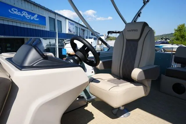 Slide: The Image of 2026 Harris Cruiser 210 boat interior with captain's chair and steering wheel. - 10
