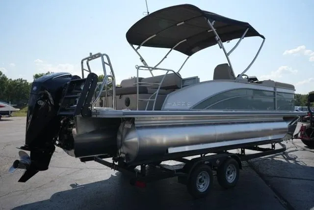 Slide: The Image of 2026 Harris Cruiser 210 pontoon boat on trailer, featuring a canopy and outboard motor. - 5