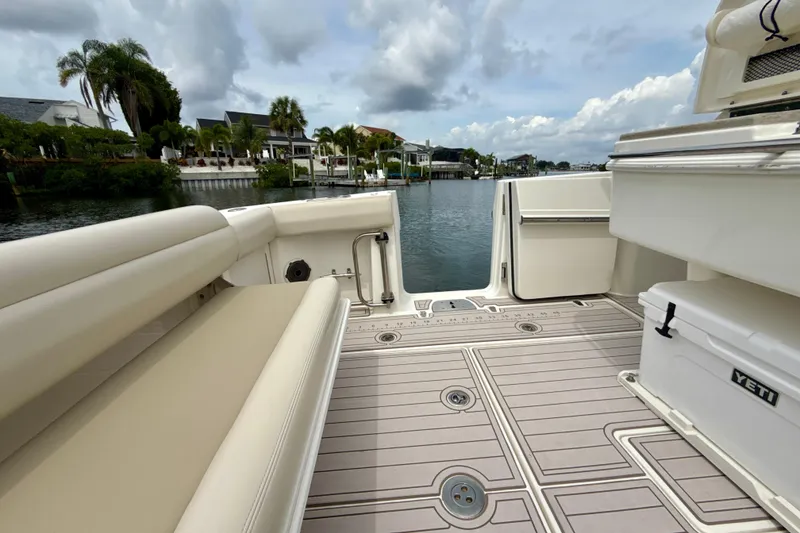 Slide: The Image of 2019 Boston Whaler 330 Outrage boat interior with seating and water view. - 19