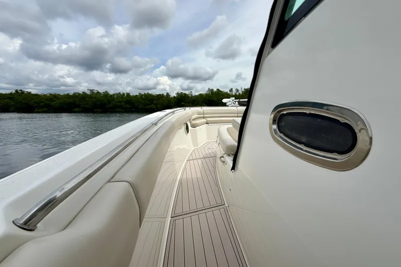 Slide: The Image of 2019 Boston Whaler 330 Outrage boat deck with sleek design and scenic water view. - 21