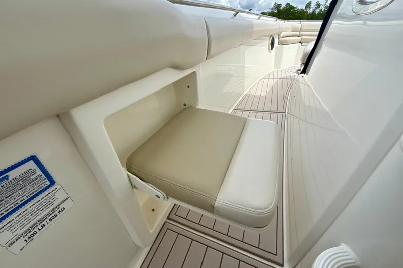Slide: The Image of 2019 Boston Whaler 330 Outrage boat interior with foldable seat and sleek design. - 23