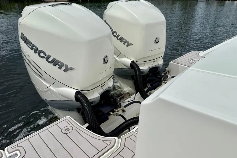 Slide: The Image of Twin Mercury outboard engines on a 2019 Boston Whaler 330 Outrage boat. - 25