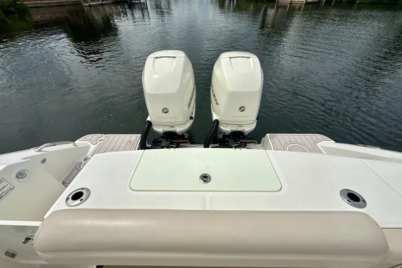 Slide: The Image of 2019 Boston Whaler 330 Outrage with twin outboard engines on calm water. - 26