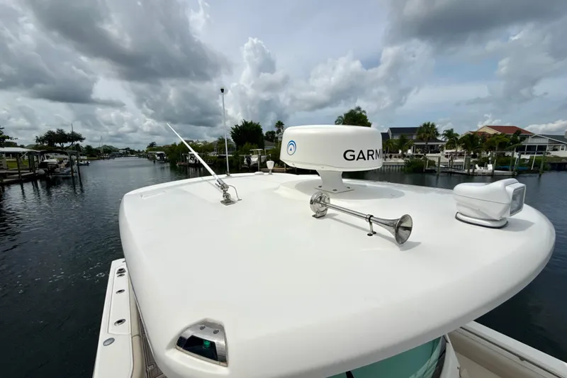 Slide: The Image of 2019 Boston Whaler 330 Outrage boat with Garmin radar on calm waterway. - 28