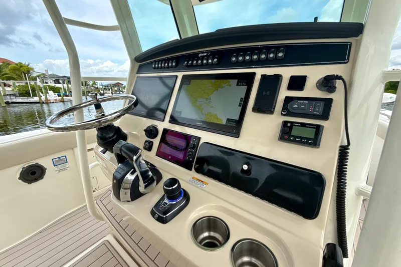 Slide: The Image of 2019 Boston Whaler 330 Outrage helm with advanced navigation and control systems. - 3