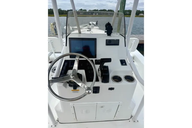 Slide: The Image of 2022 BlackJack 224 boat on calm water, rear view with clear sky. - 2