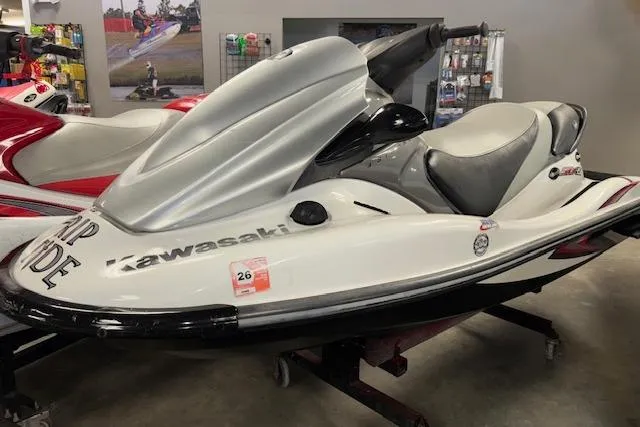Slide: The Image of 2008 Kawasaki Jet Ski STX-15F in showroom, white and silver design, side view. - 3