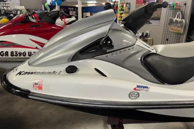 Slide: The Image of 2008 Kawasaki Jet Ski STX-15F in showroom, side view, white and gray design. - 4