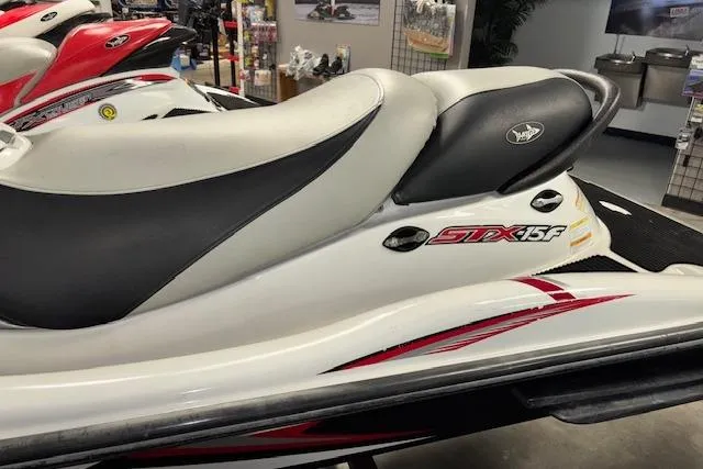 Slide: The Image of 2008 Kawasaki Jet Ski STX-15F with sleek white and black design in showroom. - 5