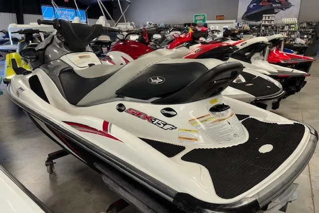 Slide: The Image of 2008 Kawasaki Jet Ski STX-15F in showroom, white and black design, side view. - 6