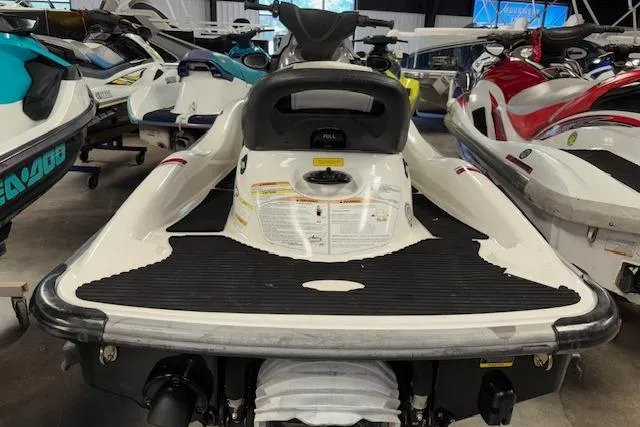 Slide: The Image of 2008 Kawasaki Jet Ski STX-15F in showroom, rear view, surrounded by other watercraft. - 8