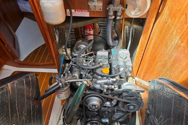Slide: The Image of Engine compartment of a 2003 Hunter 386 sailboat, showcasing detailed mechanical components. - 13
