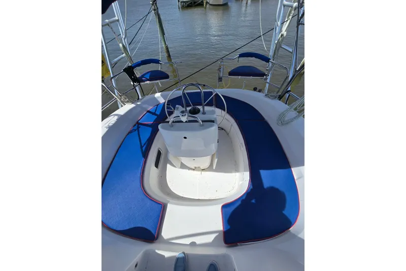 Slide: The Image of Cockpit of 2003 Hunter 386 sailboat with blue seating and steering wheel. - 3