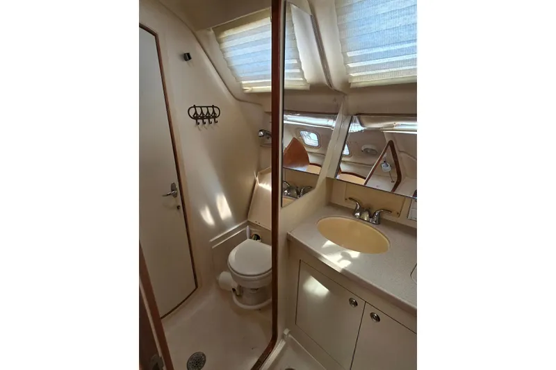 Slide: The Image of Bathroom interior of 2003 Hunter 386 yacht with sink, toilet, and mirror. - 32