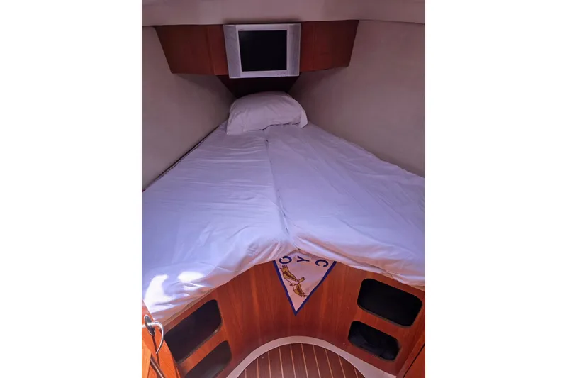 Slide: The Image of Cozy cabin interior of 2003 Hunter 386 sailboat with bed and TV. - 34