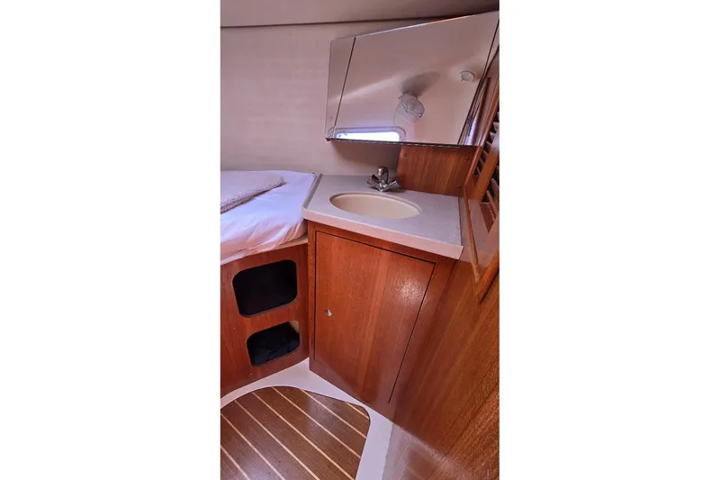 Slide: The Image of 2003 Hunter 386 yacht interior with wooden cabinetry and compact sink area. - 35