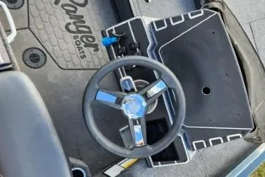 Slide: The Image of Steering wheel of 2025 Ranger ALPHA 208 boat, featuring sleek design and branding. - 2