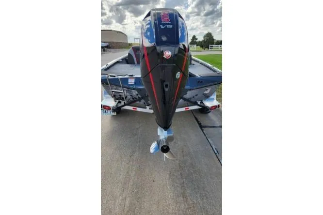 Slide: The Image of 2025 Ranger ALPHA 208 boat with V8 engine on trailer, parked outdoors. - 5