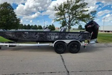 Slide: The Image of 2025 Ranger ALPHA 208 boat on trailer, parked outdoors under a cloudy sky. - 8