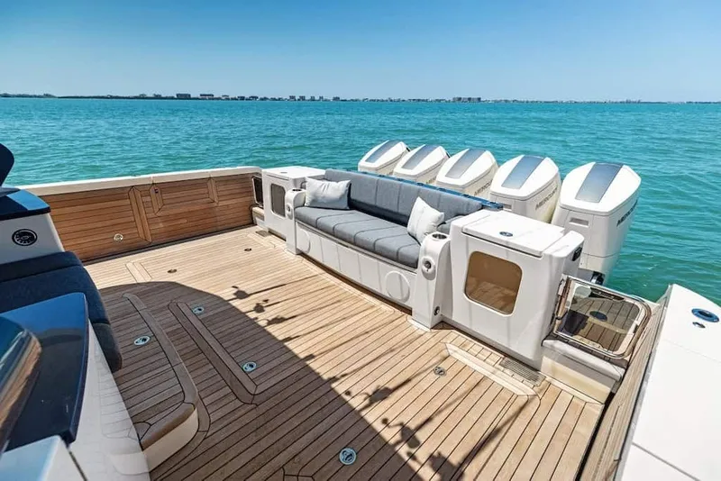 Slide: The Image of Luxurious 2026 Scout 670 LX boat deck with seating, overlooking serene blue waters. - 14