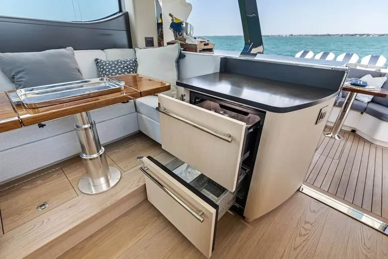 Slide: The Image of Luxurious interior of 2026 Scout 670 LX yacht with open drawers and elegant seating. - 22