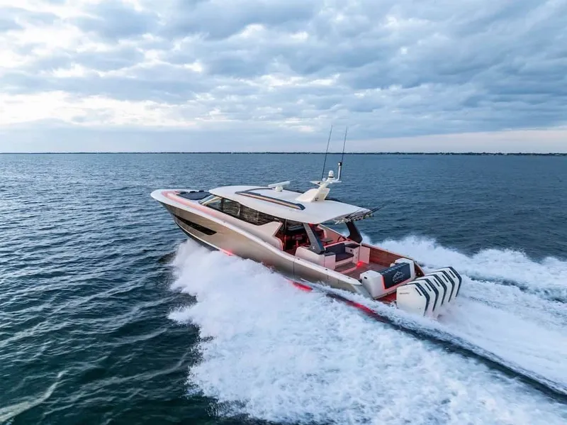 Slide: The Image of 2026 Scout 670 LX yacht cruising on open water under a cloudy sky. - 42