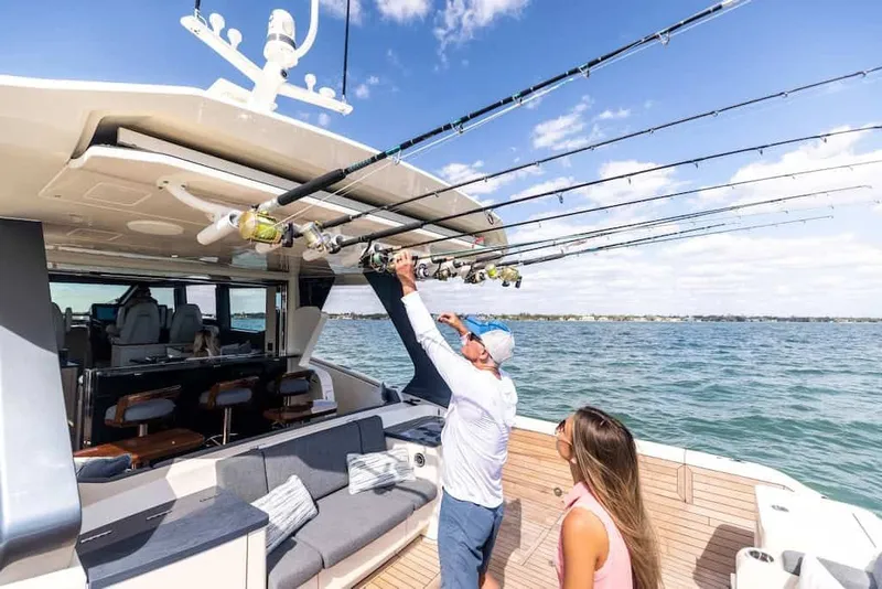 Slide: The Image of 2026 Scout 670 LX boat with fishing rods, two people enjoying a sunny day on the water. - 9