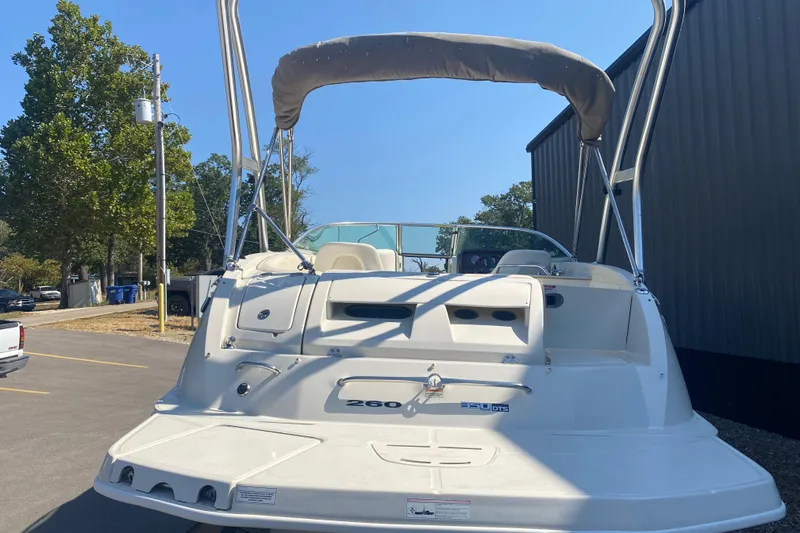Slide: The Image of 2008 Sea Ray 260 Sundeck boat with canopy, parked outdoors on a sunny day. - 3