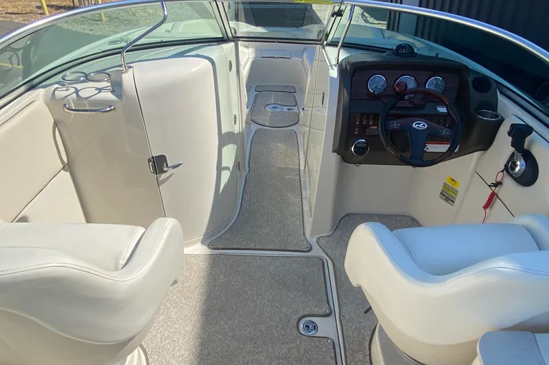 Slide: The Image of 2008 Sea Ray 260 Sundeck interior with helm, seating, and dashboard controls. - 4