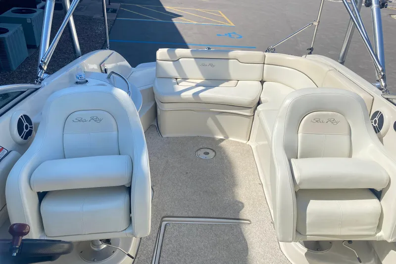 Slide: The Image of 2008 Sea Ray 260 Sundeck interior with white seating and steering wheel. - 6