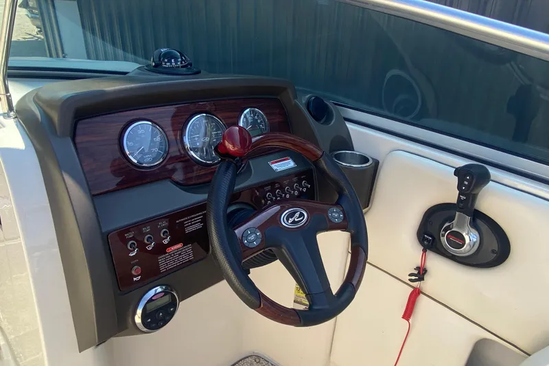 Slide: The Image of Dashboard of a 2008 Sea Ray 260 Sundeck boat with steering wheel and controls. - 7