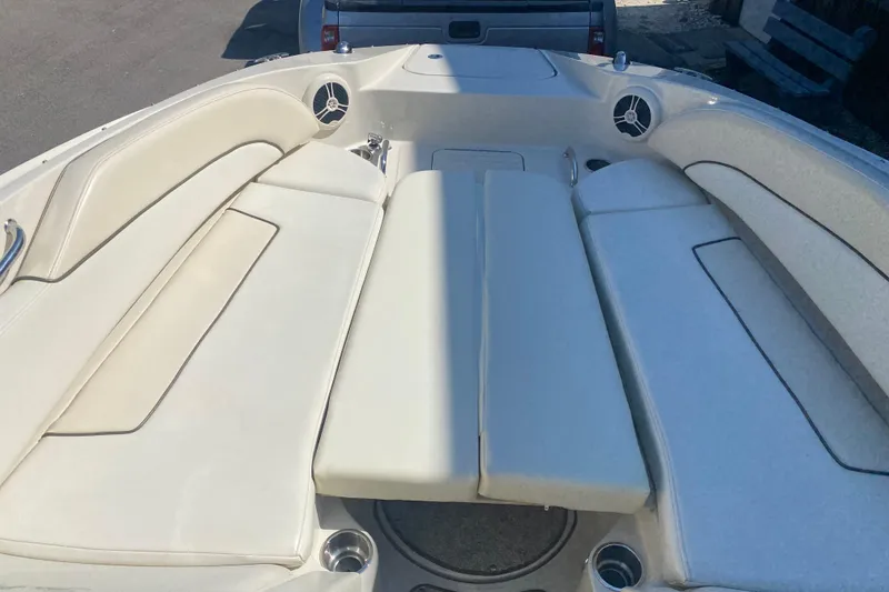 Slide: The Image of 2008 Sea Ray 260 Sundeck boat interior with cushioned seating and cup holders. - 9