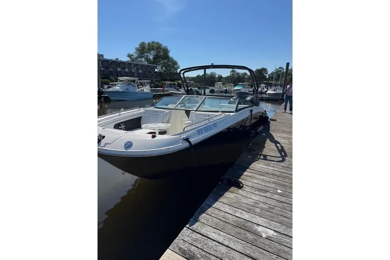The Image of 2019 Sea Ray SDX 290 Outboard docked at a marina under clear skies. - 0