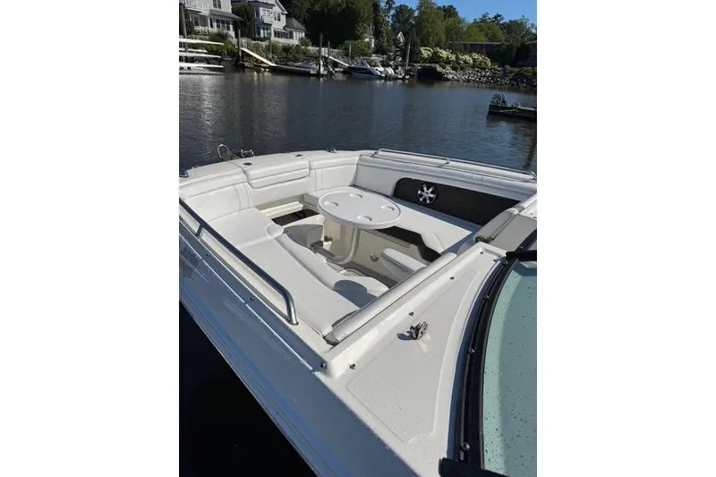 Slide: The Image of 2019 Sea Ray SDX 290 Outboard boat with spacious seating and table on calm water. - 10