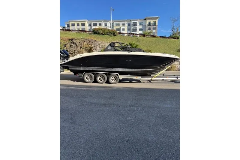 Slide: The Image of 2019 Sea Ray SDX 290 Outboard boat on a trailer, parked roadside. - 14