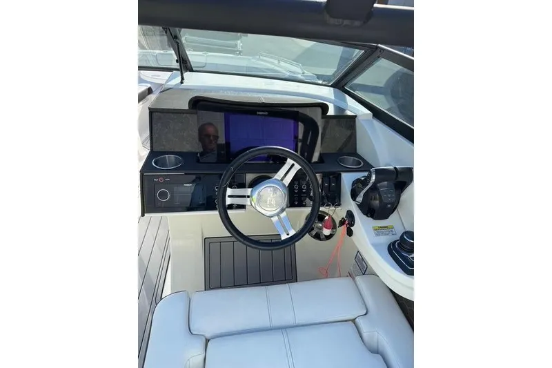 Slide: The Image of 2019 Sea Ray SDX 290 Outboard helm with modern controls and steering wheel. - 15
