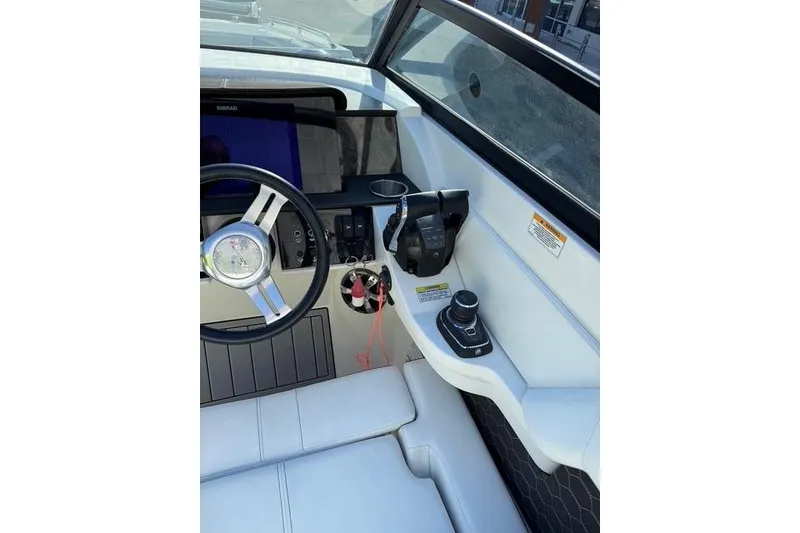 Slide: The Image of 2019 Sea Ray SDX 290 Outboard helm with steering wheel and controls. - 16