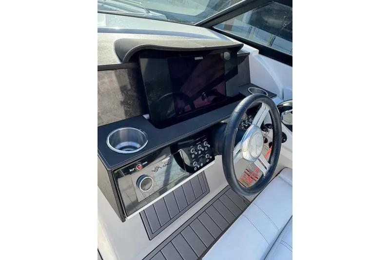 Slide: The Image of 2019 Sea Ray SDX 290 Outboard helm with steering wheel and control panel. - 21